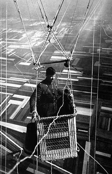  Close-up view of an American major in the basket of an observation balloon flying over territory near front lines during World War I. 